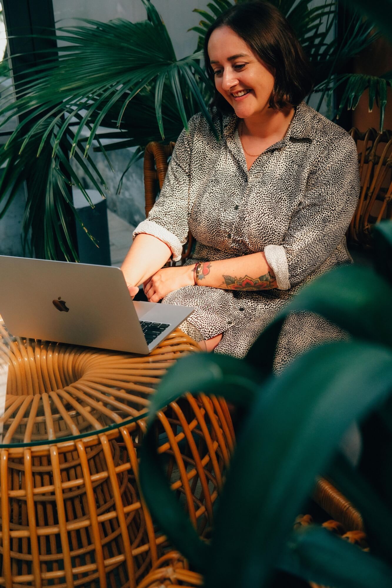 Sophie Bellamy - a woman in her mid-thirties with short brown hair - works on a silver Apple laptop