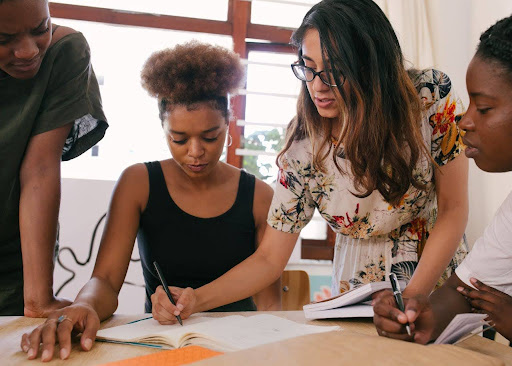 Four people working together at a desk